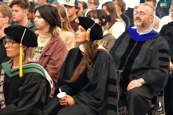 Dr. Jennifer Olson sits with students at BSU's 2023 Convocation.