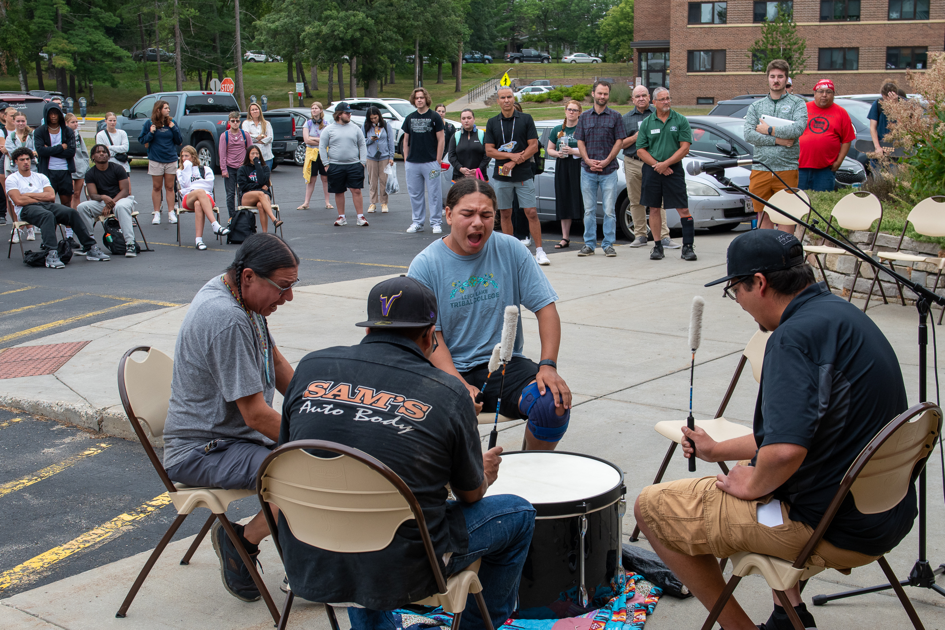 A traditional drum group signs an honor song