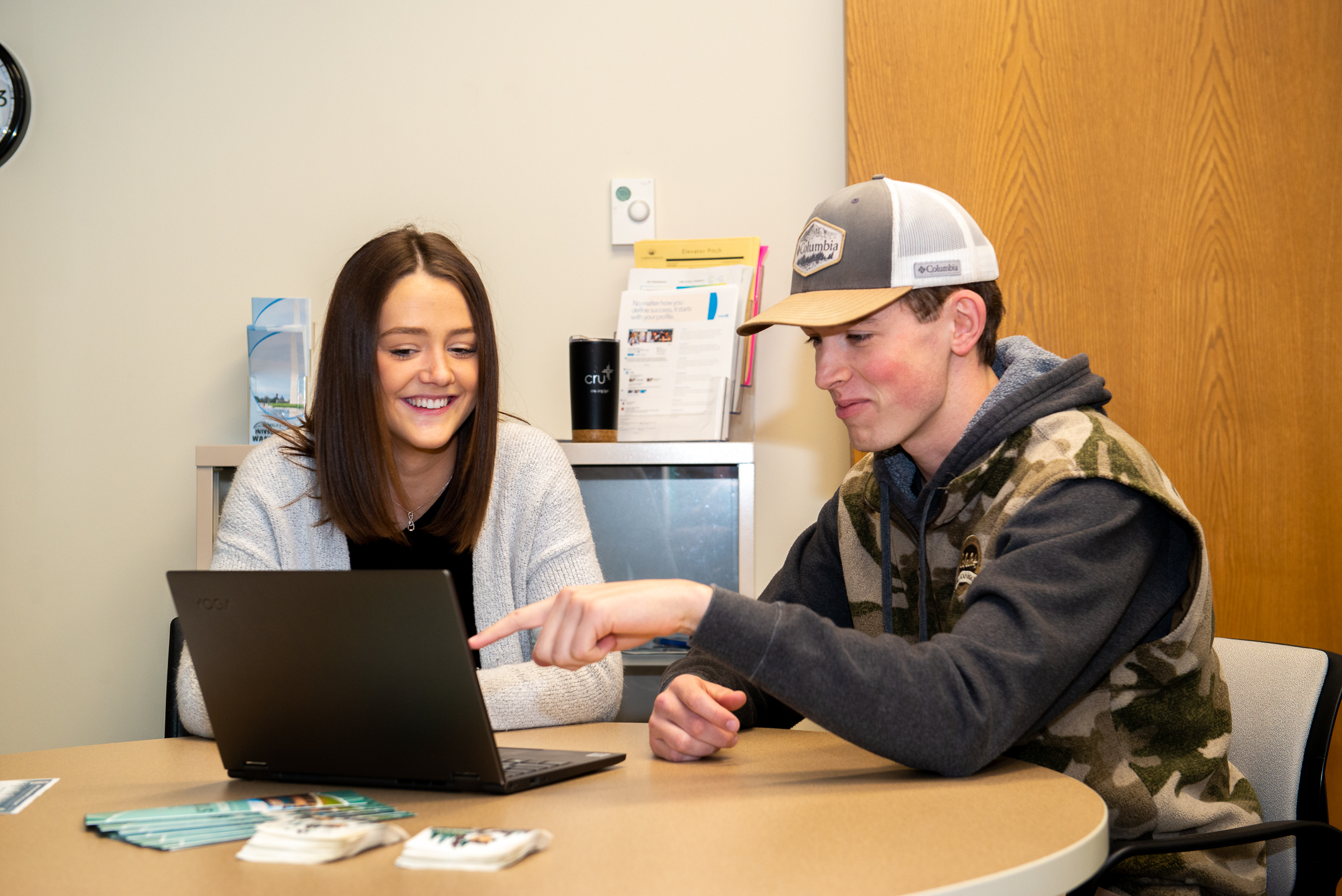 Two students look at a computer