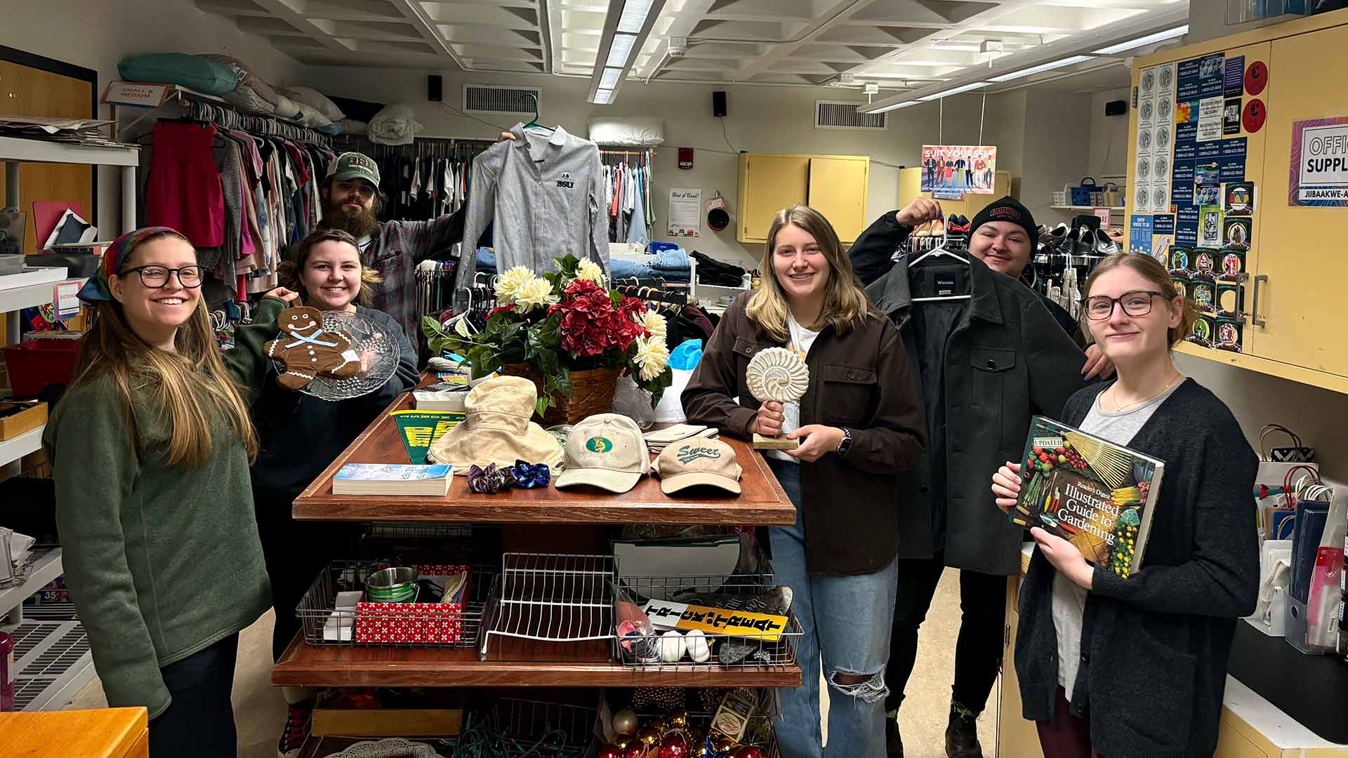 Students are posing by a table in the BSU Free Store