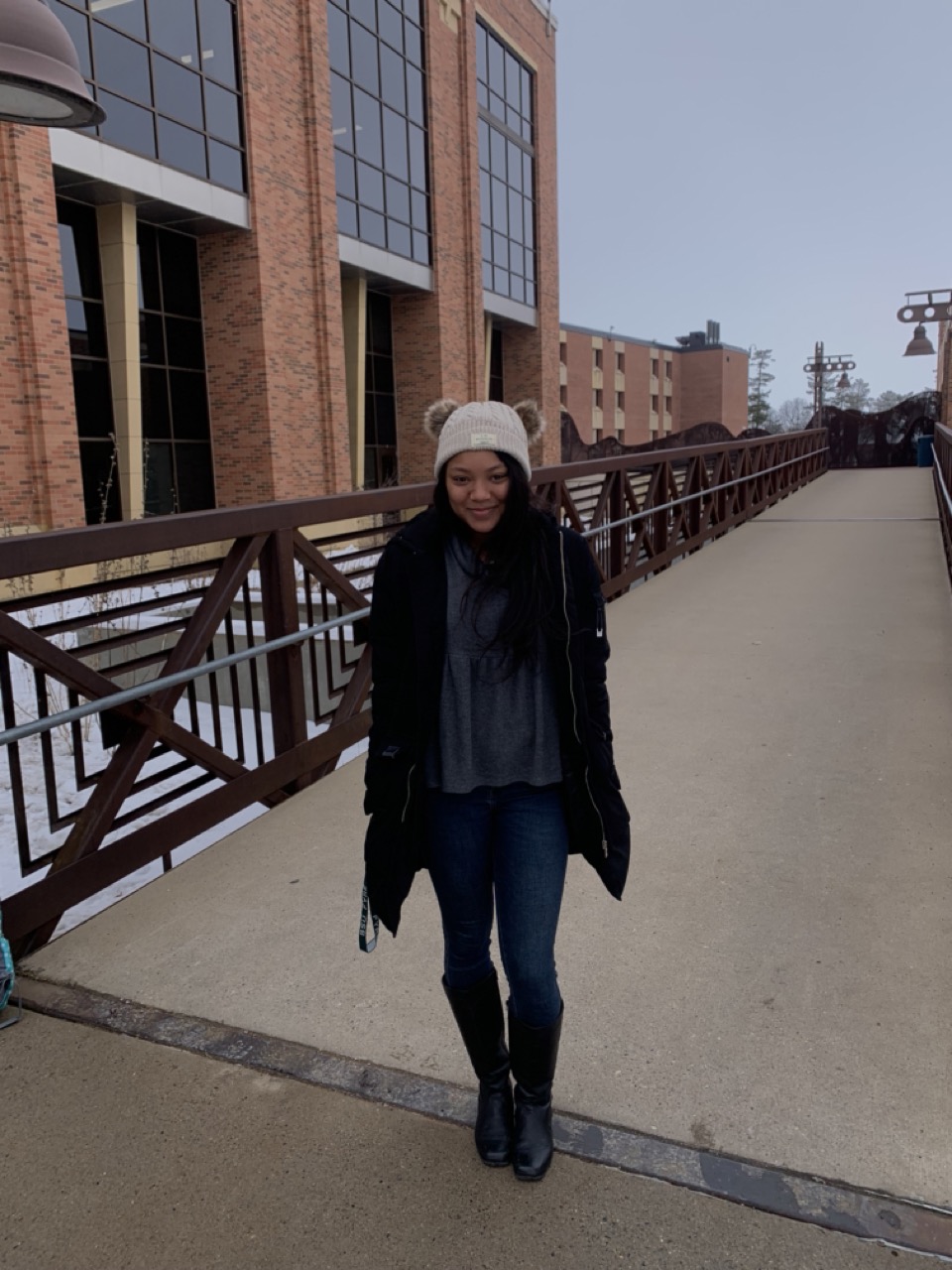 Juliana Nixon in a winter coat on a bridge in winter