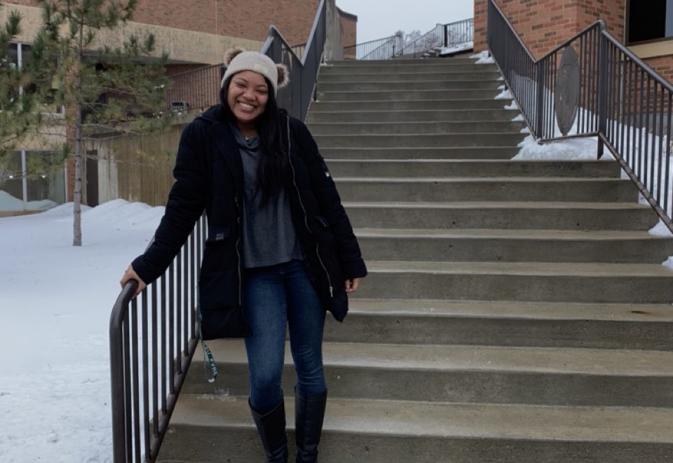 Juliana Nixon standing on outdoor stairs with snow in the foreground