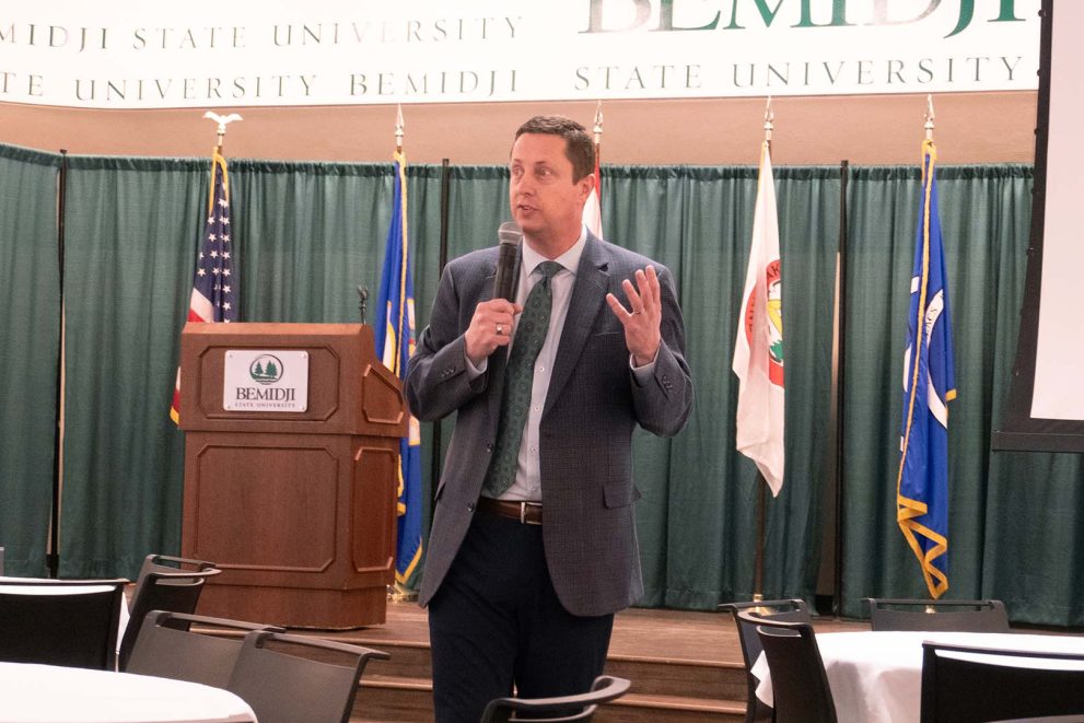 A stock image of BSU President John L. Hoffman speaking in front of a podium in BSU's Beaux Arts Ballroom