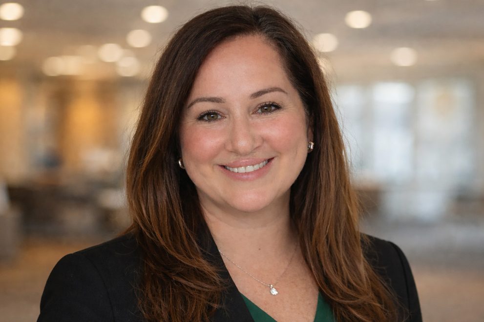 A portrait of Amanda Longie; she's wearing a dark jacked with a BSU green shirt underneath.