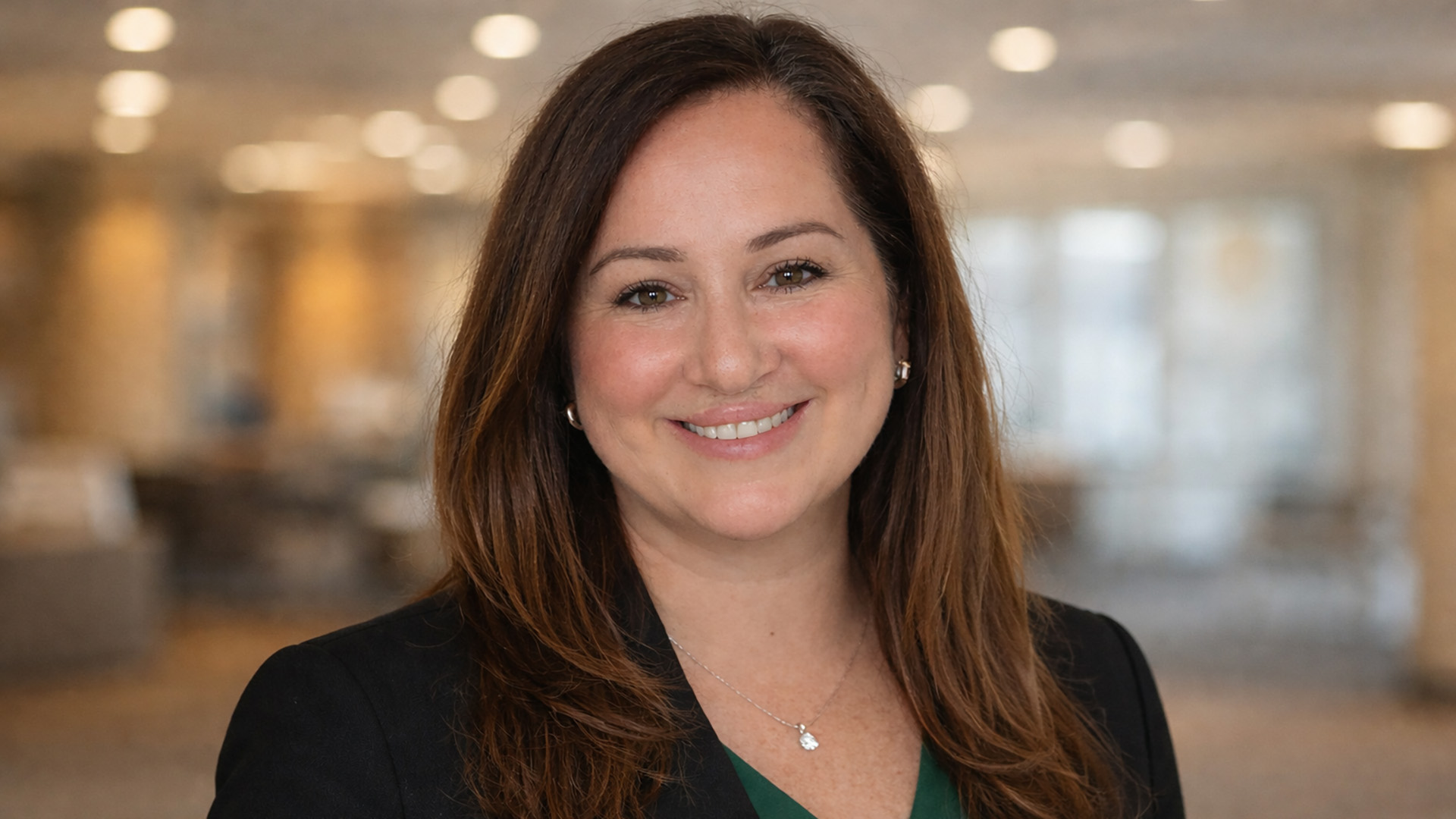A portrait of Amanda Longie; she's wearing a dark jacked with a BSU green shirt underneath.