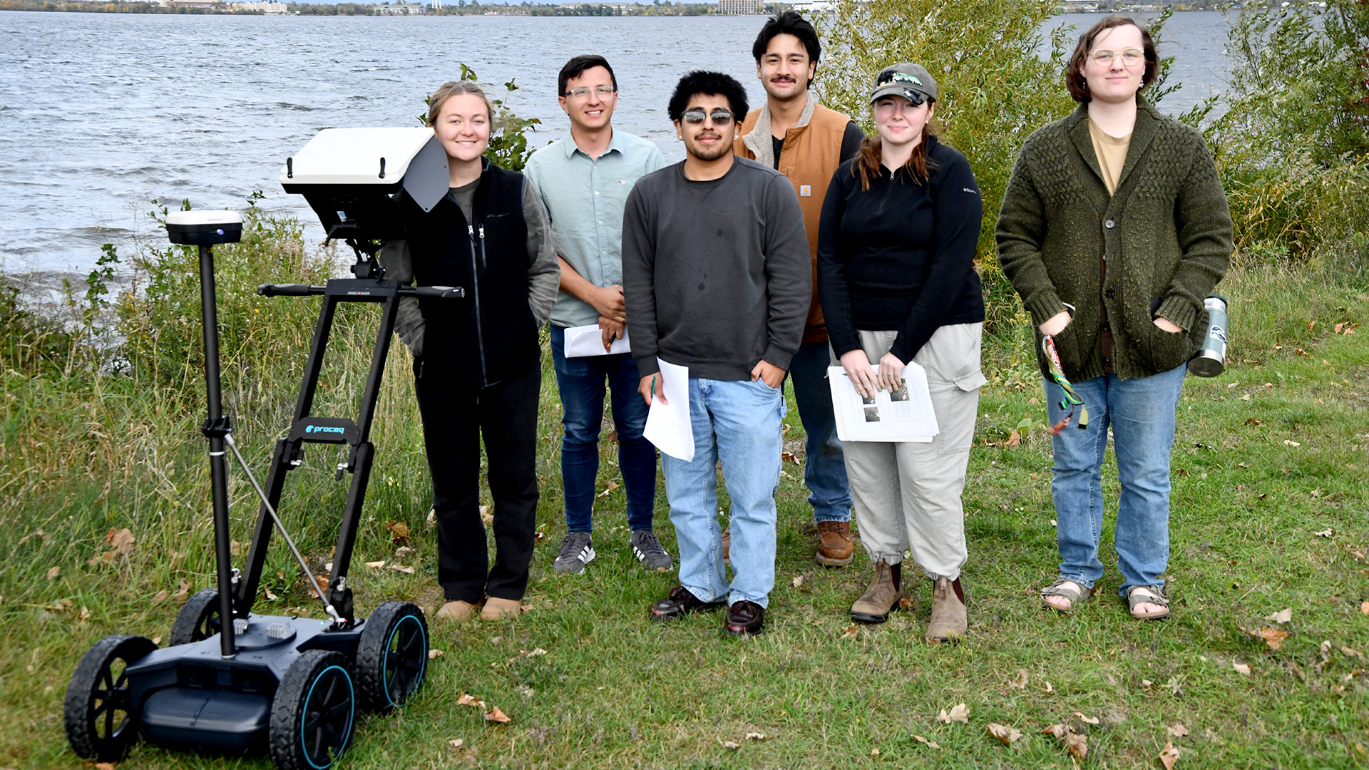 BSU students using a GPR on the Lake Bemidji shore behind campus.