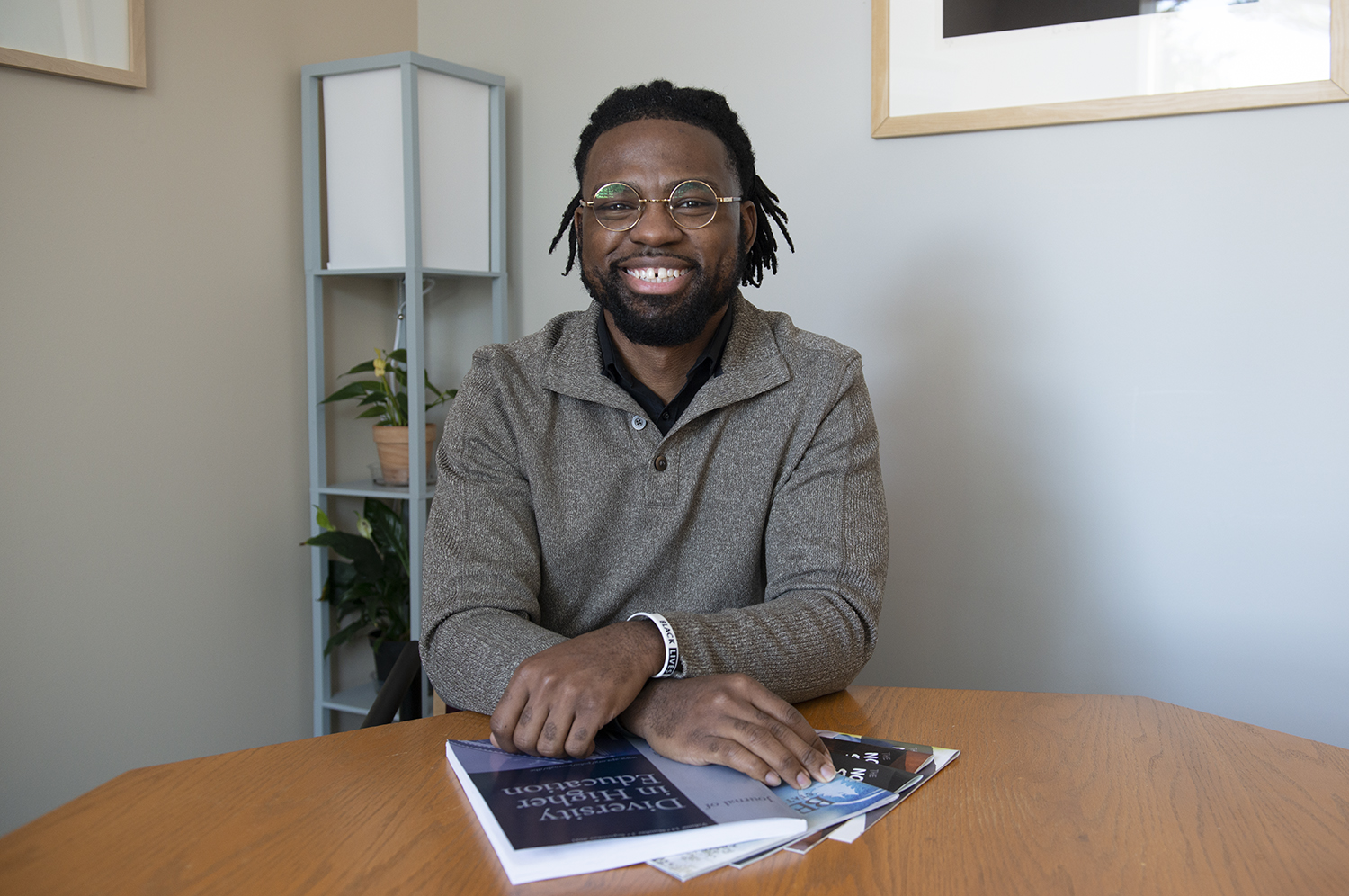 Steven Parker sitting at table holding diversity books