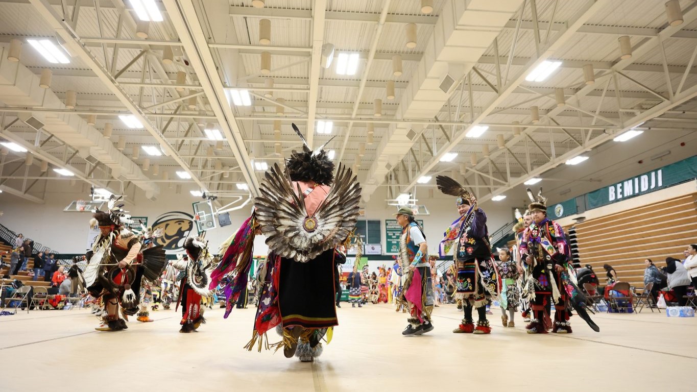 An Indian Pow Wow with many people in attence