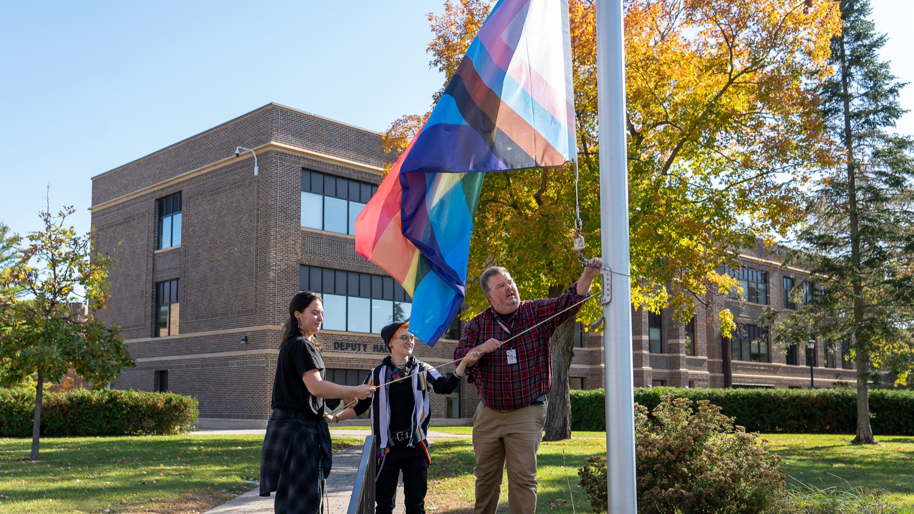 Students and Staff Raising Pride Flag