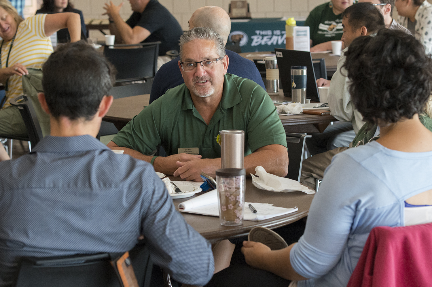 Faculty and staff members discussing at a table