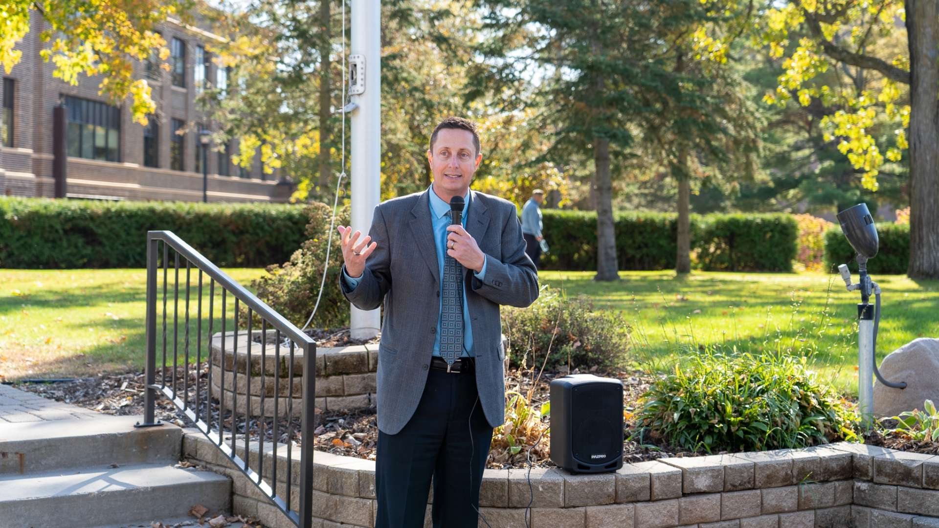 John Hoffman standing outside a flag pole on the Bemidji State campus
