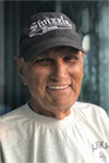 A candid photo of R. Allen Sunderman; he is wearing a long-sleeved t-shirt and a dark grey baseball cap.