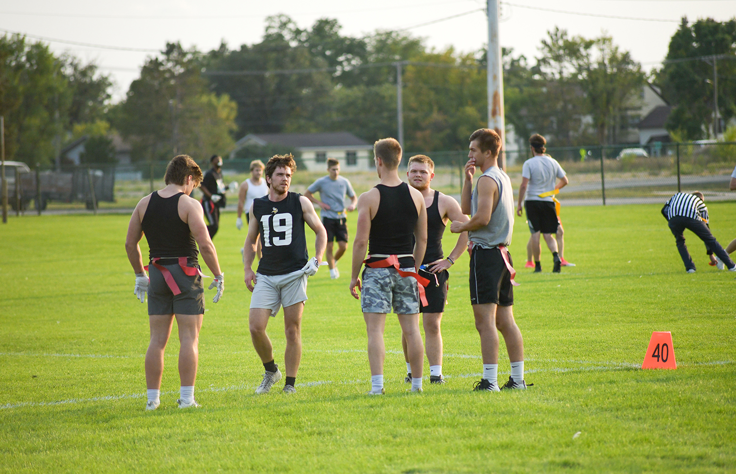 A group strategizing during flag football