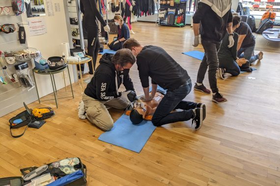 Two students learning CPR on a dummy