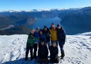 BSU student on HVL's exchange program in Norway in front of lake and mountains