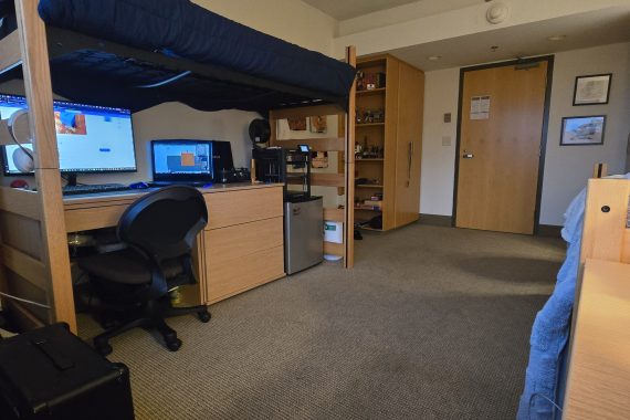 Birch double room with a bed lofted and desk underneath.