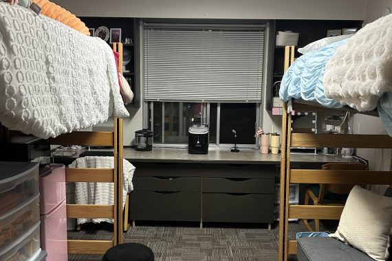 Oak double room with both beds lofted and a mini refrigerator and storage under the left bed and a futon under the right bed.