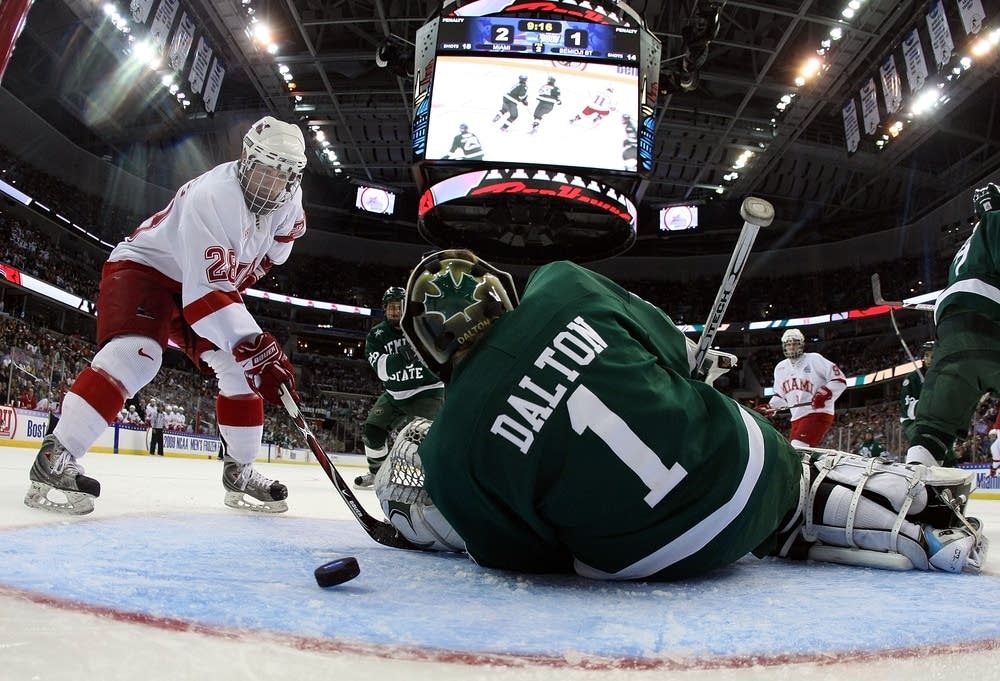 Bemidji State hockey goalie trying to prevent a goal