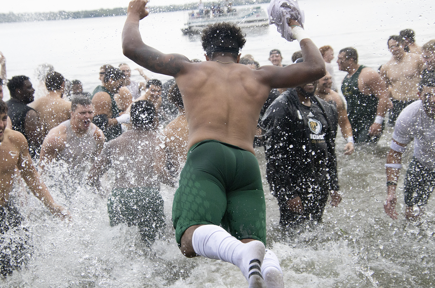 BSU football team jumping into Lake Bemidji after winning the homecoming game in 2022