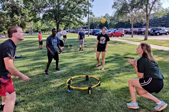 Students playing spikeball outside