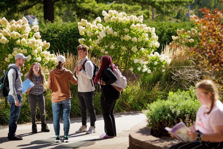 Students talking in a circle outside Deputy Hall